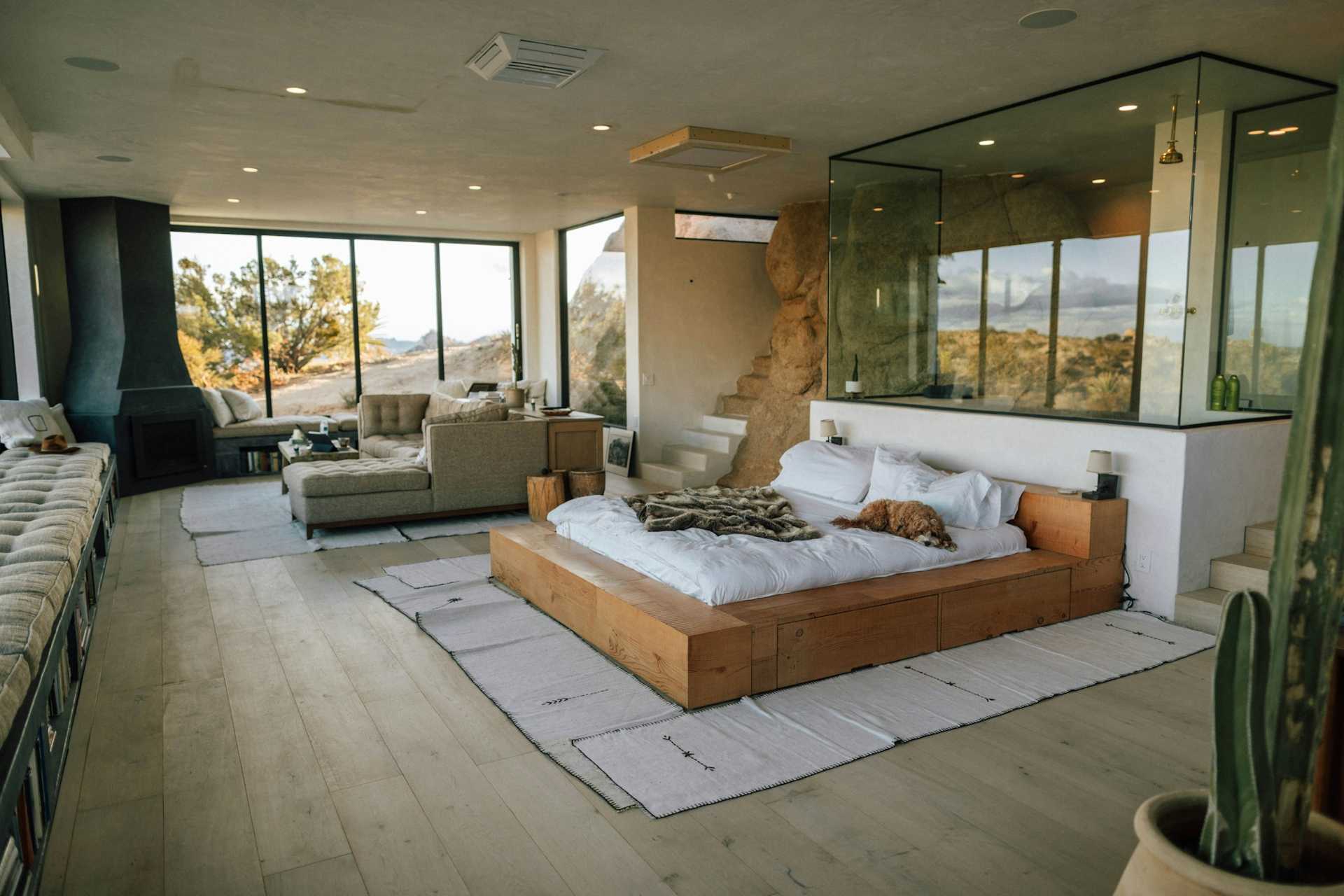 Joshua Tree interior with pale wood, neutral seating, and wide desert-facing windows.