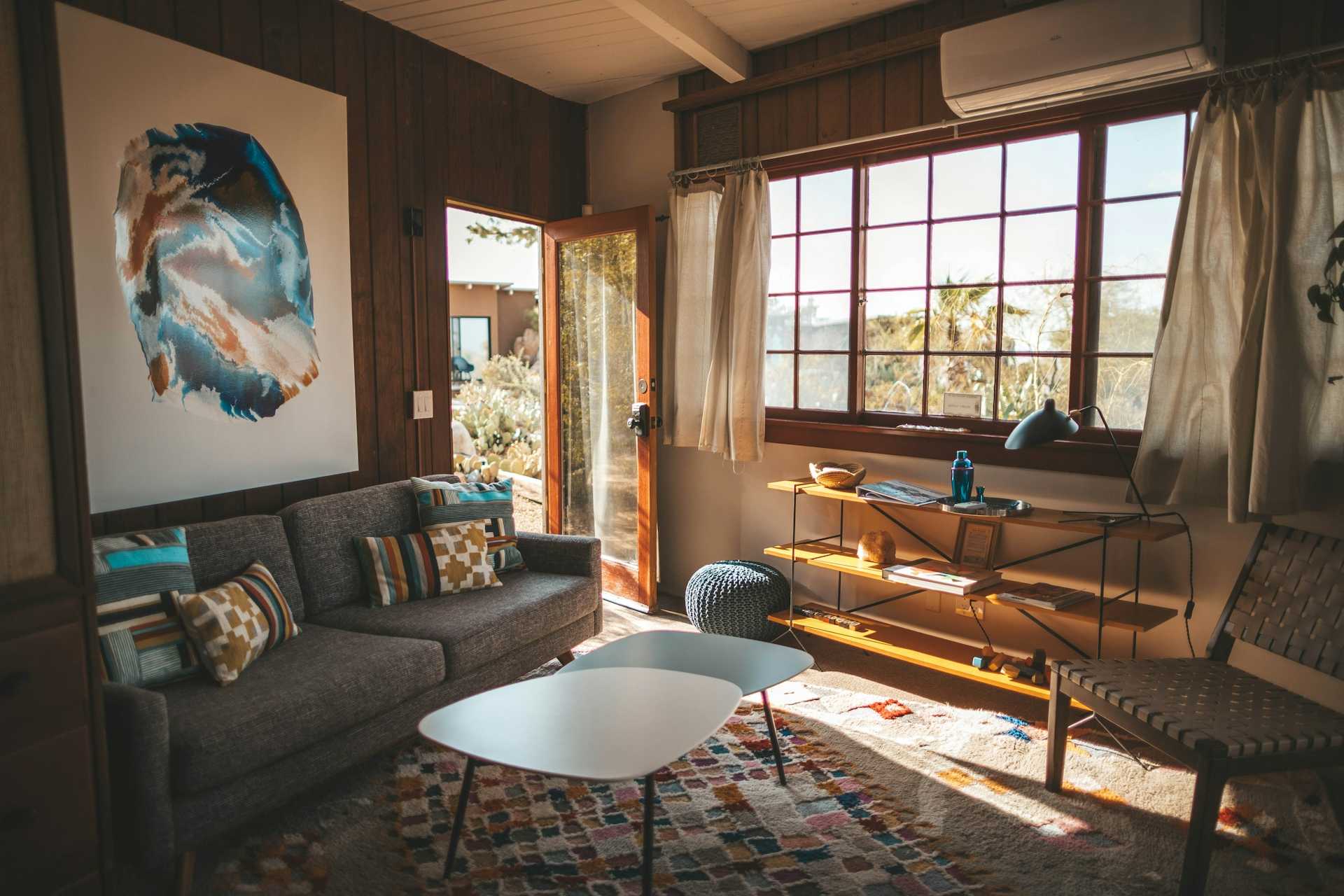 Joshua Tree living area with a white table, brown seating, and warm natural light.